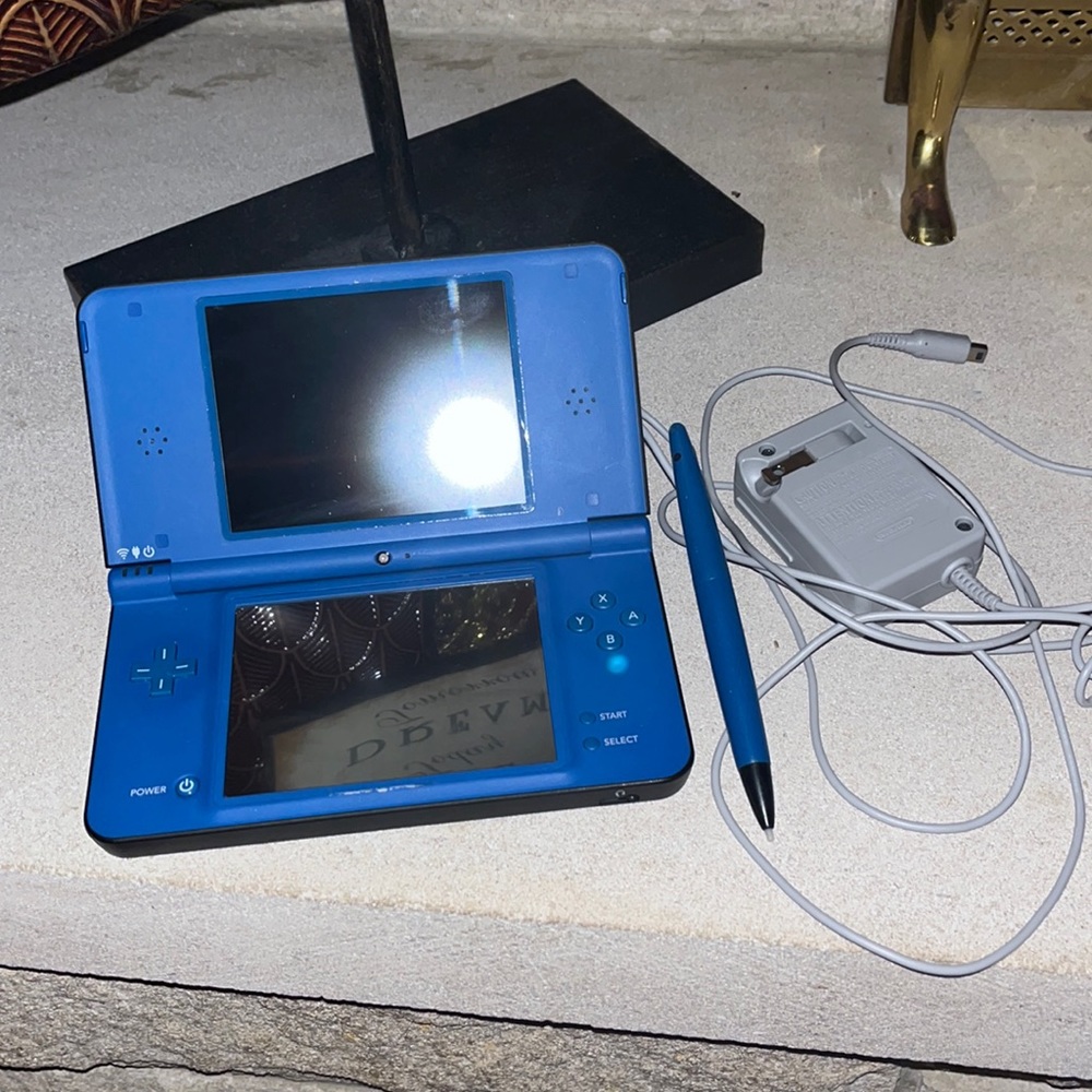 Blue Nintendo DSi with charger and large stylist.